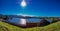 Panoramic photo of water reservoir in the city of Pocos de Caldas with blue sky and sun shining in the sky with lens flare