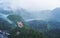 Panoramic pine forest and Hohenschwangau castle with foggy environment in Germany