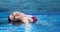 Panoramic portrait of beautiful young natural woman, in red bikini, with brunette hair relaxes swimming content happy in holidays