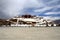 The panoramic of the Potala Palace, with the people republic of China flag inside as well as Potala Palace square, trees and meado