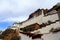 The panoramic of the Potala Palace, with the people republic of China flag inside as well as Potala Palace square, trees and meado