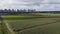 Panoramic rotation over fields and distant city aerial view