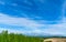 Panoramic rural landscape with mountains. Vast blue sky and white clouds over farmland field