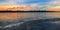 Panoramic scene with frozen lake and factory in background