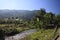 Panoramic scenic view of Nam Song Xong river amidst trees and rural karst hills landscape against blue clear sky