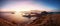 Panoramic scenic view of Padar Island during sunset.