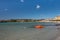 Panoramic sea and beach views against the backdrop of the Golfo Aranci mountains, Sardinia. In the foreground catamaran