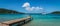 Panoramic sea and harbor view with wooden pier at the beach of Bequia, St Vincent and the Grenadines.