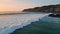 Panoramic sea waves splashing sunrise coastline. Rocky dawn cliffs foaming water