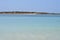 Panoramic seascape : beach with palette of blue and small islet. Mallorca, Spain