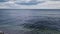 Panoramic seascape with a sailboat on the horizon