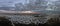 Panoramic seaside sunset at winter season with dramatic sky with dark stratocumulus clouds and rough sea with lots of white sea