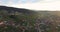 Panoramic shooting sunrise over small town in a wooded valley