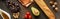 Panoramic shot of avocado, tomatoes, grape, baguette, olive oil, peanuts, quail eggs on marble surface.