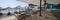 Panoramic shot of a beach with sunloungers and straw umbrellas on a sunny day