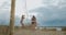 Panoramic shot of beach volleyball court with playing women, professional training of sportswomen, friendly match