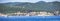 Panoramic shot of boats on the sea with buildings background in Rabac City, Croatia