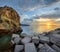 Panoramic shot of the breakwater cube blocks at the coast of Vulcano Island at sunrise, Eolian Islands, Sicily, Italy.