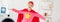 panoramic shot of child in red homemade suit with star sign having fun