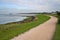 Panoramic shot of the coastal landscape with rural dirt road in Amrum, North Sea, Germany