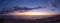 Panoramic shot of a colorful breathtaking sunset over the ocean