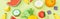 Panoramic shot of colorful handmade paper fruits isolated on green.