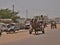 Panoramic shot of a donkey pulling a simple platform wagon with a man in Nouakchott, Mauritania.
