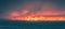 Panoramic shot of dramatic sunset cloudy sky over sea or ocean in stormy windy weather
