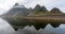 Panoramic shot of the Eystrahorn mountain chain with beautiful reflections in the water.