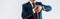 Panoramic shot of mature businessman in suit looking at watch isolated