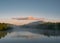 Panoramic shot a misty lake with a mountainous landscape background