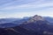 Panoramic shot of mountains with a thin cirrus cloud against a blue sky background