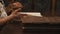 Panoramic shot old woman leaf through book russian cursive text on table