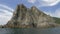 Panoramic shot from the open sea of rocks and cliffs near the coastline. Rocky sea coastline. Beautiful natural