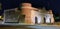 Panoramic shot of Porta Nuova stone defense gate at night in Verona, Italy.