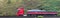 Panoramic shot of a red truck driving on the road