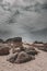 Panoramic shot of rocky shore of CarnotaÂ´s Beach with a stormy cloud background