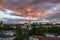 Panoramic shot of a small town with a church at the middle under an orange cloudy sky