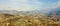 Panoramic Sierra Nevada mountains landscapee on a sunny day with soft clouds