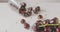 Panoramic slow motion close-up of a sweet ripe red cherry in a glass bowl on a white table and blurred background of