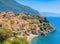 Panoramic of a small and colorful Mediterranean coastal village between the sea and the mountains