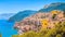 Panoramic of a small and colorful Mediterranean coastal village between the sea and the mountains