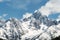 Panoramic snow mountain with white clouds and blue sky