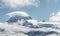 Panoramic snow mountain with white clouds and blue sky