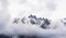 Panoramic snow mountain with white cloudy sky