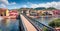 Panoramic spring cityscape of Bosa town with footpath bridge across the Temo river. Picturesque morning view of Sardinia island, I