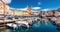 Panoramic summer cityscape of Bastia port with twin-towered Church of St. Jean-Baptiste rising behind it. Stunning afternoon view