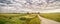 Panoramic summer landscape with gravel road