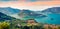 Panoramic summer view of Iseo lake. Impressive sunrise on Marone town with Monte Isola island, Province of Brescia, Italy, Europe.