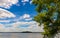 Panoramic summer view of Jezioro Selmet Wielki lake landscape with wooded island in Sedki village in Masuria region of Poland